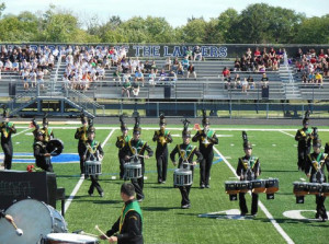 Photo courtesy of Tolguy Ture. Percussionists display athleticism and coordination during a competition.  The marching Grenadiers compete against schools from all over the state.  While marching band is a fine art, it also involves physical aspects as well.  Band members need strength, coordination and precision while performing in competitions.